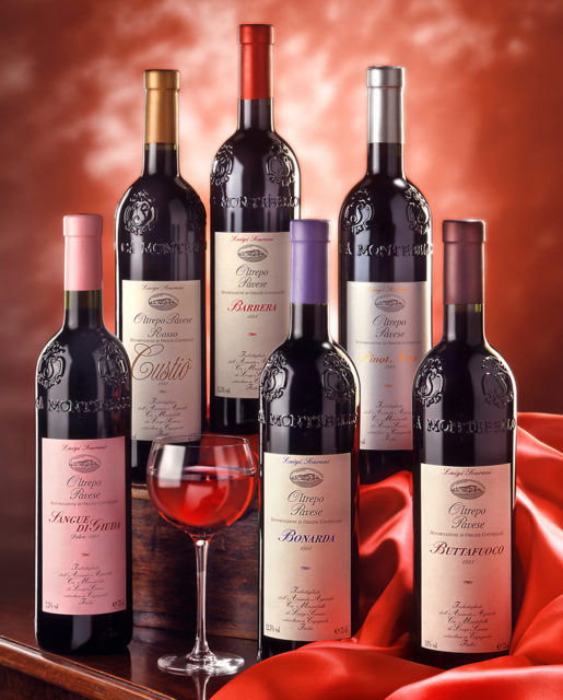 Foto still life con drappo e fondo rosso dei vini Rossi Scarani